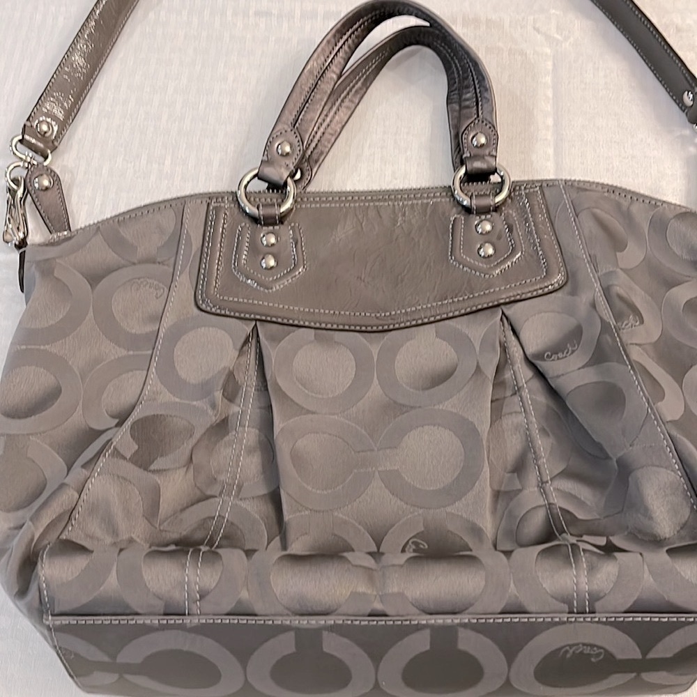 Coach Handbag. Beautiful gray with purple lining. Never used. Has shoulder strap
